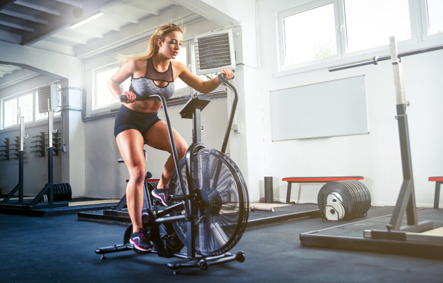 a girl on an air bike in gym